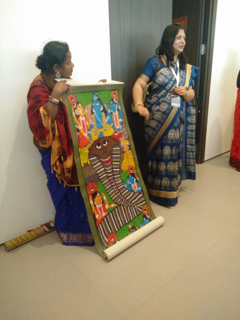 Chitrakar Monimala demonstrating the tradition of Patachitra scroll painting and the singing tradition associated with it, translated to English by a member of the organising committee.